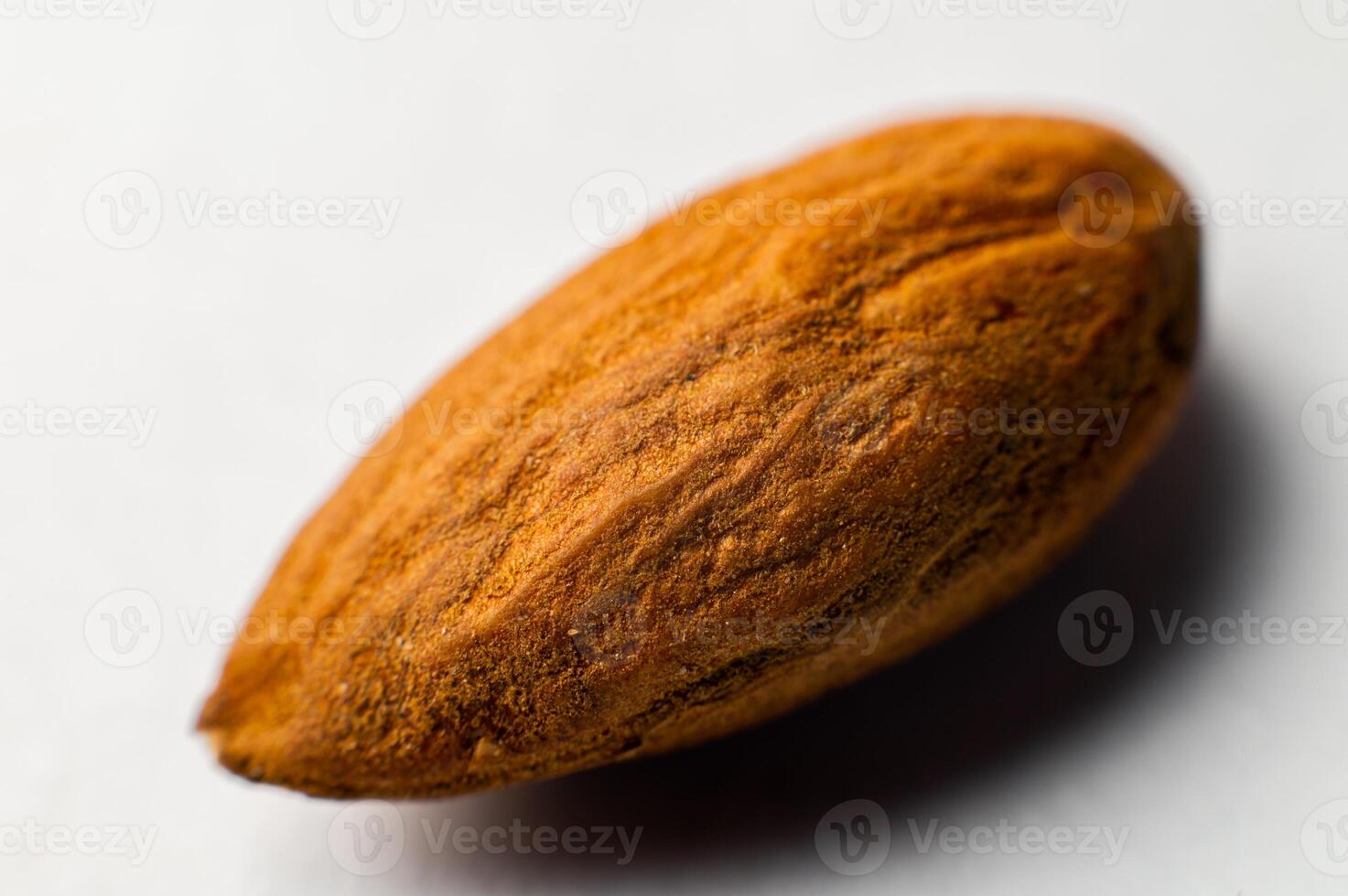 One tonsil on a white background. Almonds close-up, texture visible photo