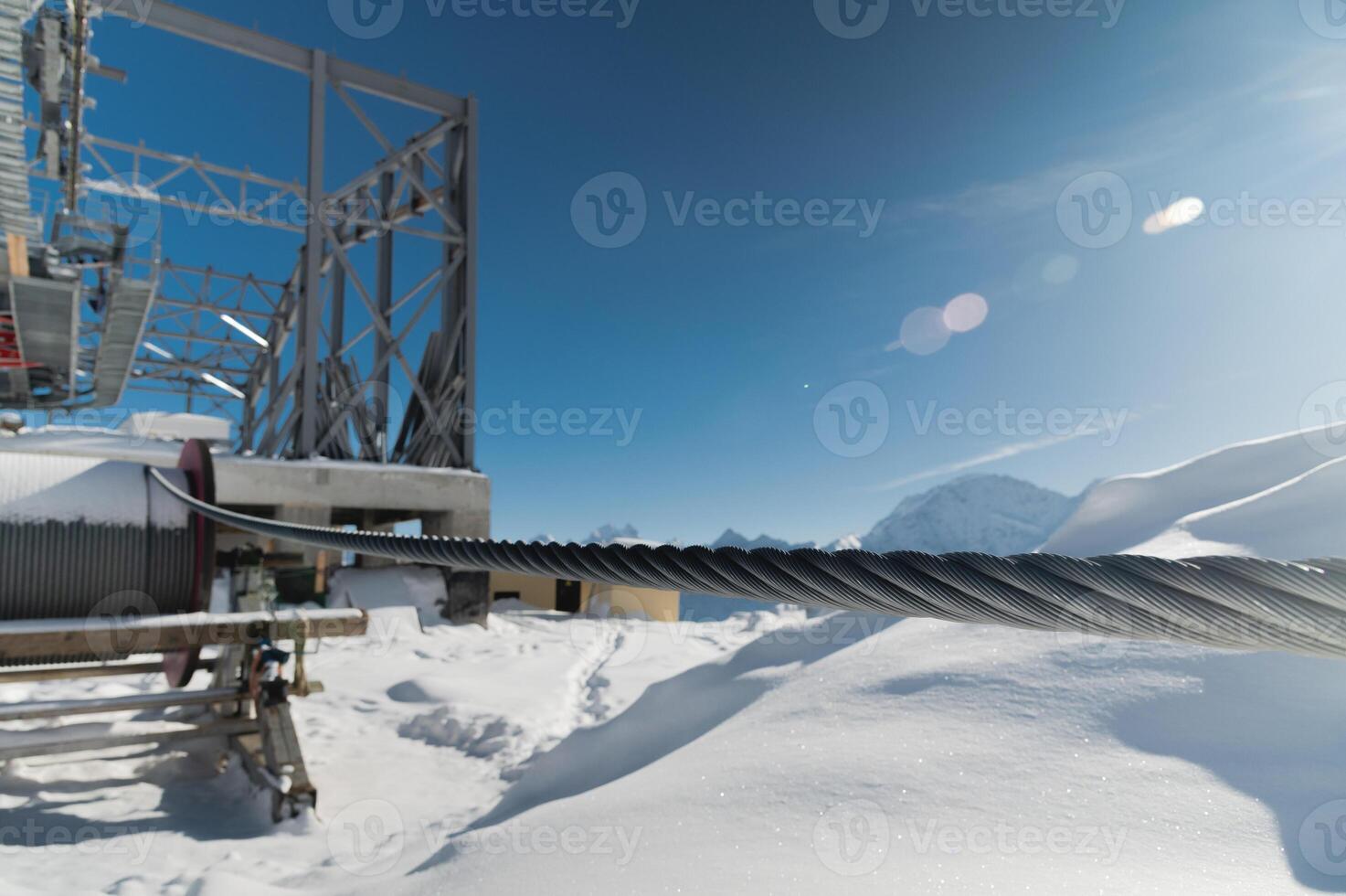 A cable car station high in the mountains under construction. Snowy mountain landscape and construction of a metal structure for a cable car photo