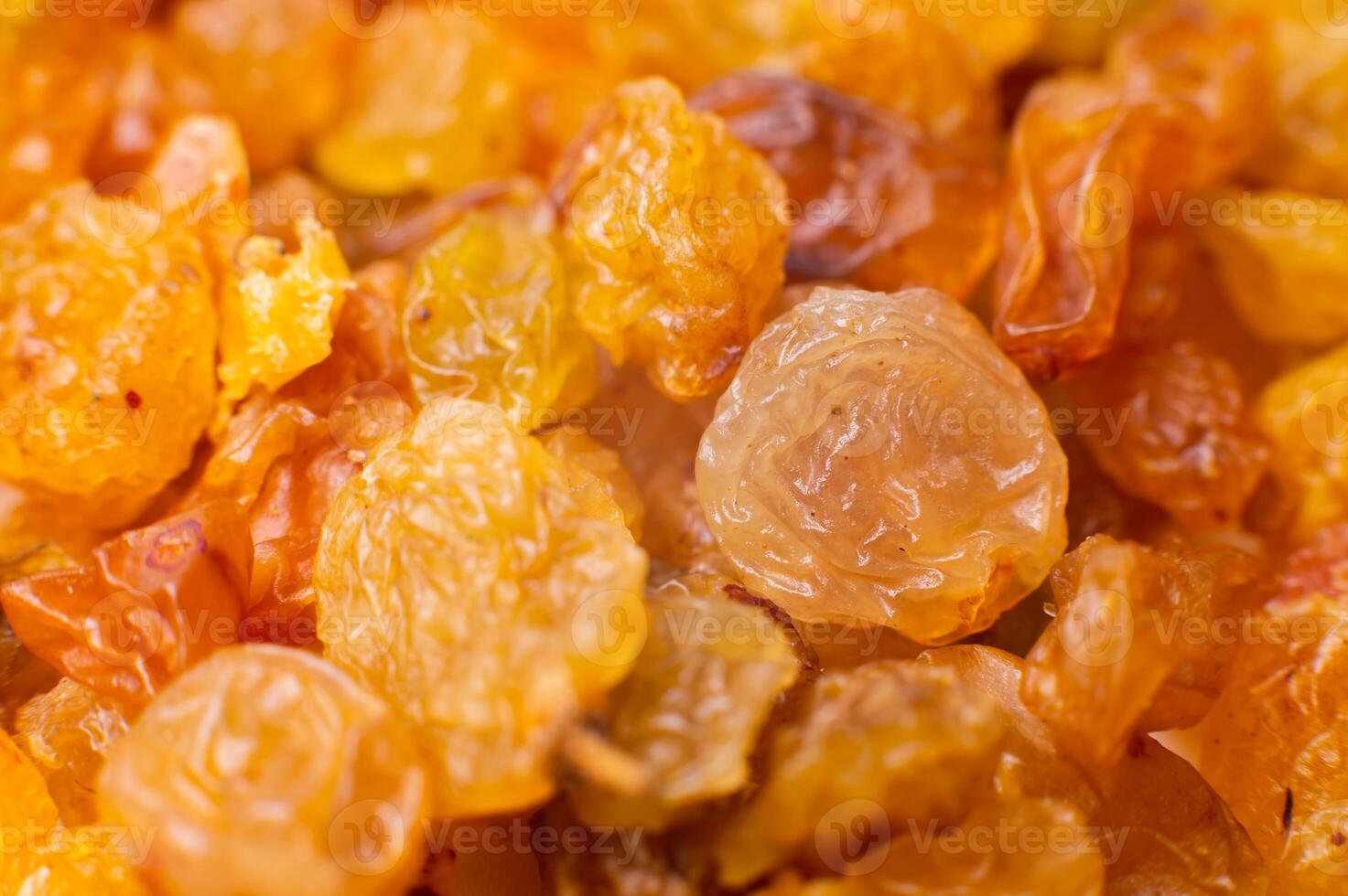 Background of a large number of dried yellow golden grapes. Raisin. Vegetarian diet photo
