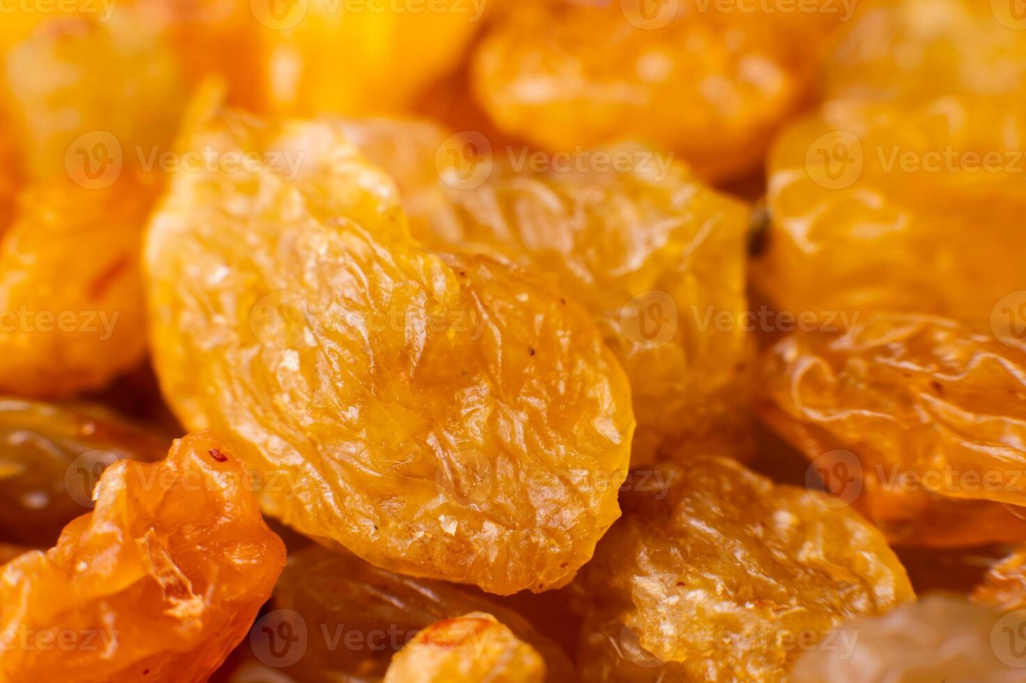 Background of a large number of dried yellow golden grapes. Raisin. Vegetarian diet photo