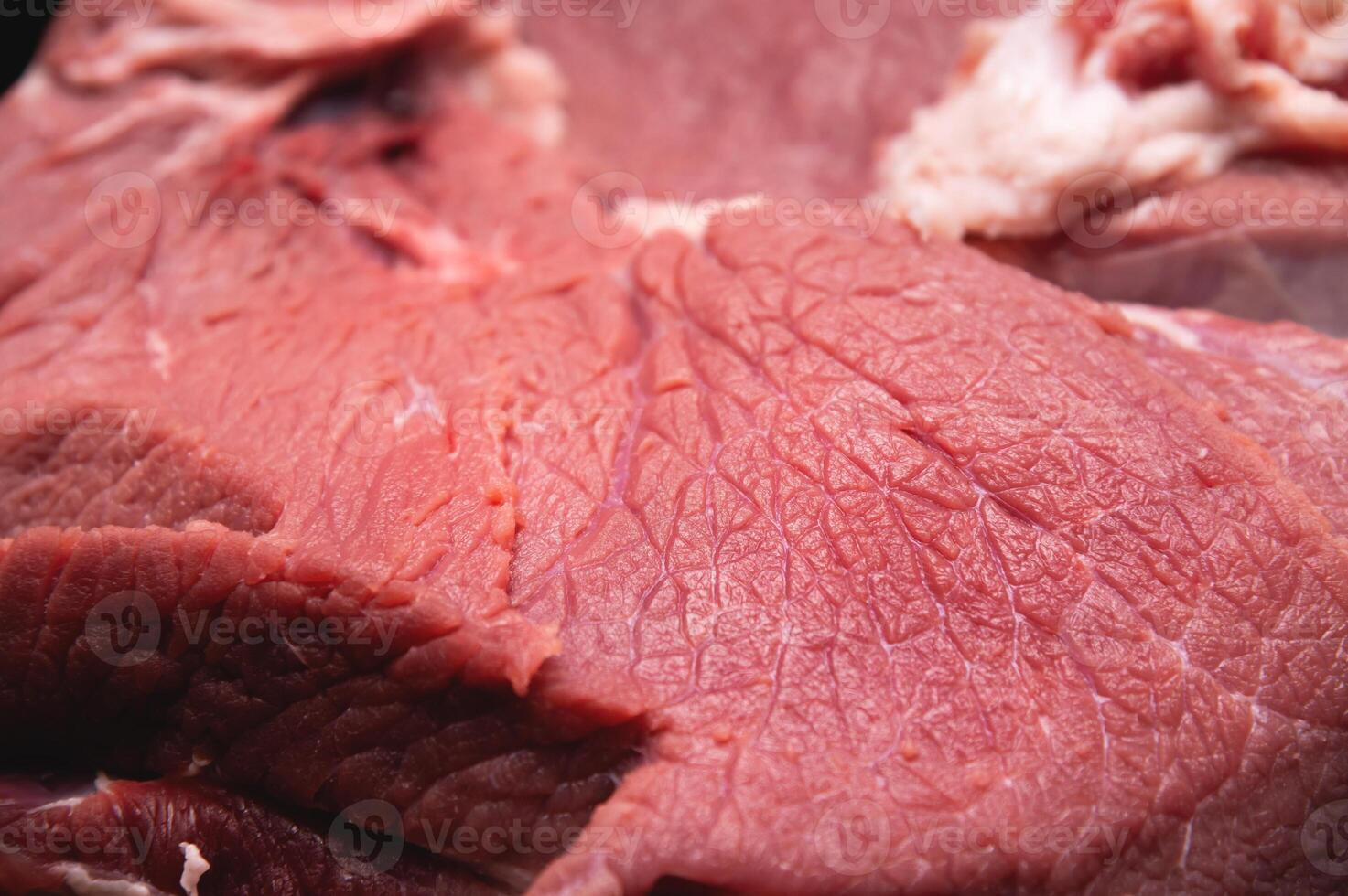 Close-up of a piece of fresh beef meat in shallow depth of field photo
