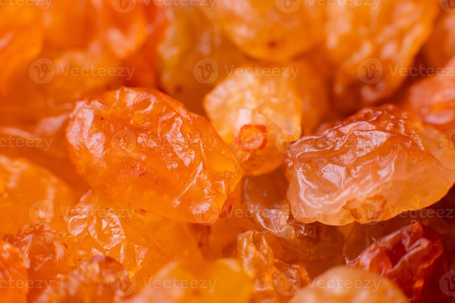 Background of a large number of dried yellow golden grapes. Raisin. Vegetarian diet photo