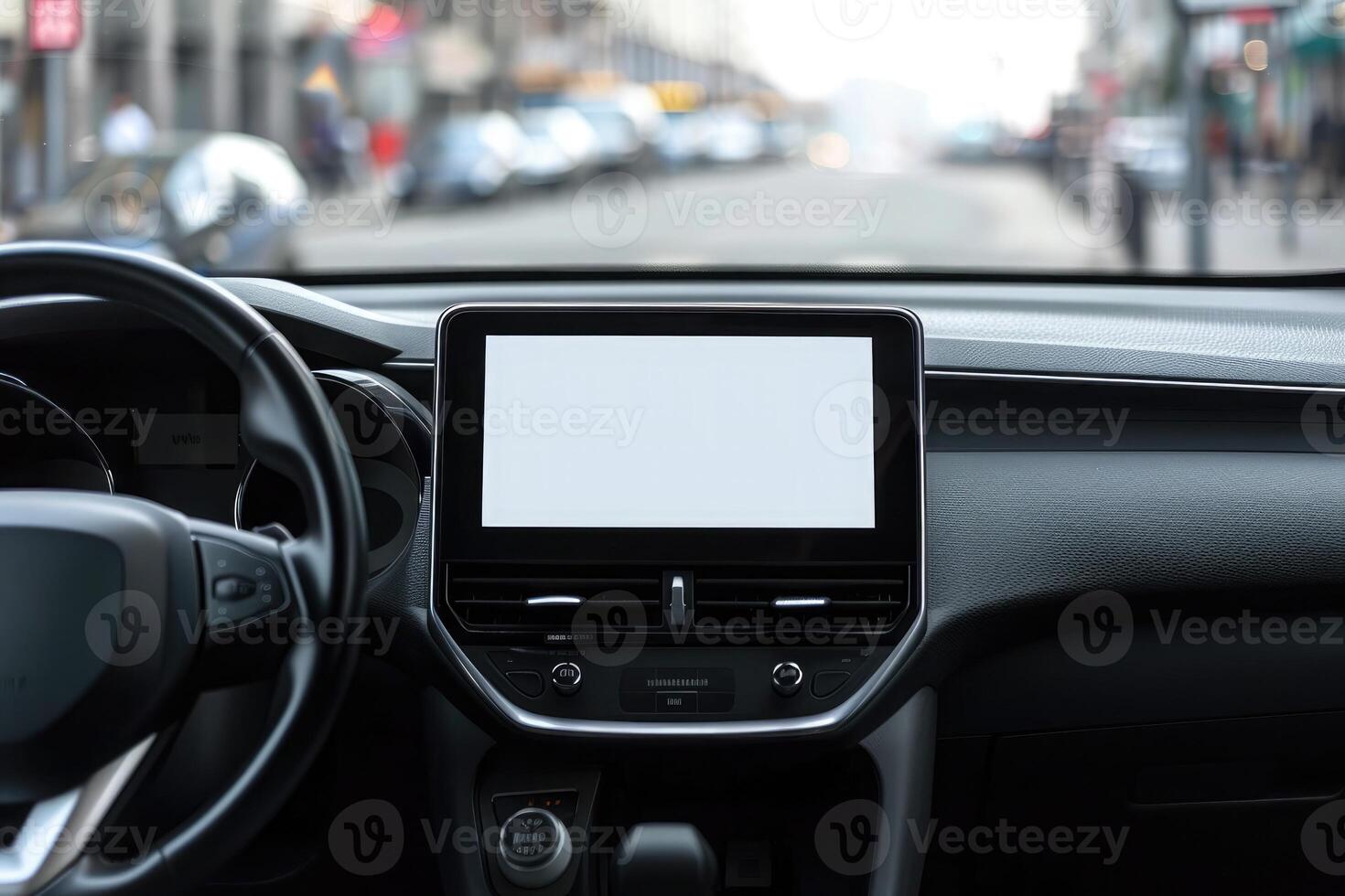 Close-up of a modern vehicle's dashboard featuring a blank infotainment screen, with a blurred street in the background photo