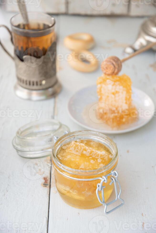 honeycomb with honey in a jar and tea from a Russian samovar with bagels,organic vitamin product as alternative medicine photo