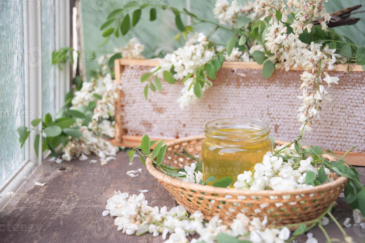 still life with full honeycombs,jar of ocacia honey on table,organic enriched beekeeping product,alternative medicine photo