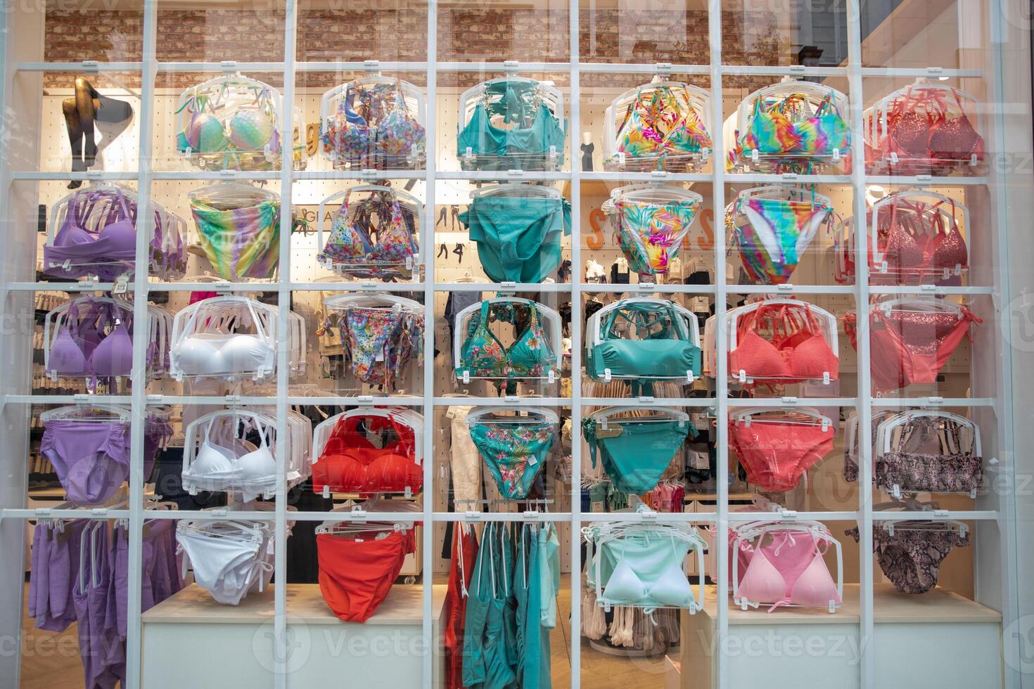 Swimwear hanging on a hanger in a showcase of a lingerie store, selective focus photo