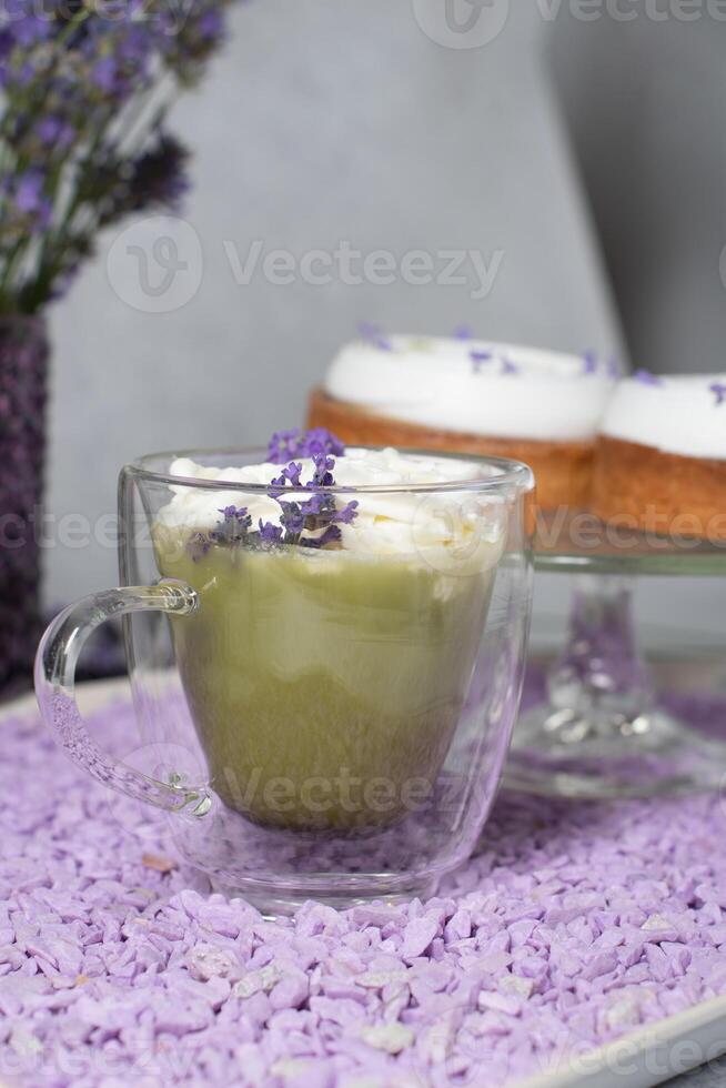 matcha green tea with mousse cakes on a table decorated with lavender flowers photo