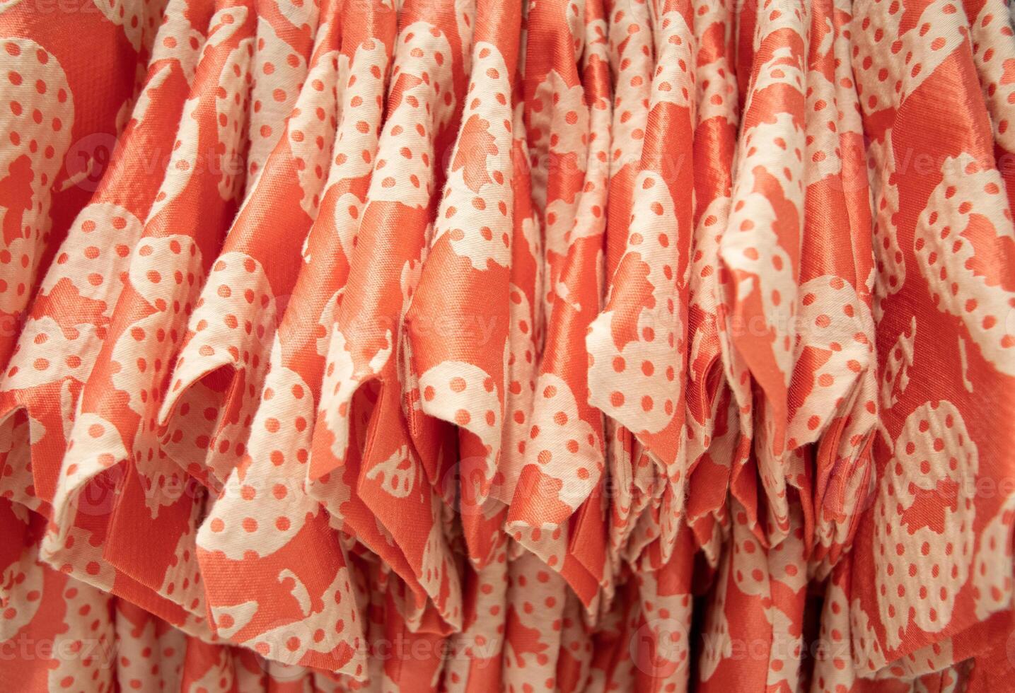 many same models orange blouses in the store grouped in the same color photo