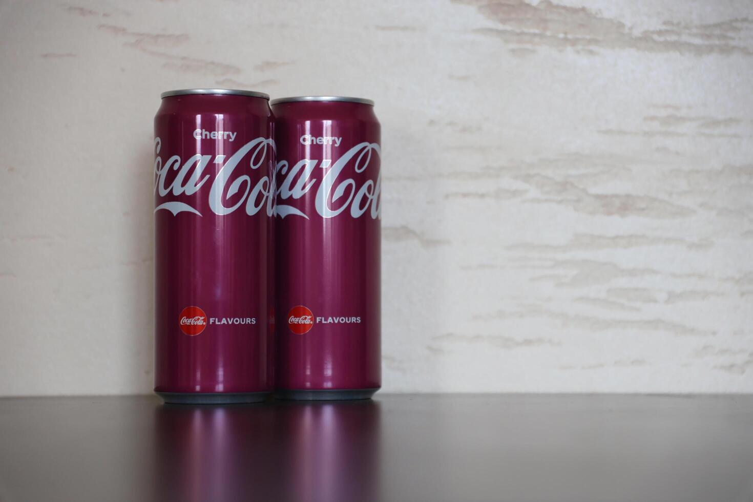 KYIV, UKRAINE - 4 MAY, 2023 Coca cola soft drinks brand tin cans with cherry flavour photo