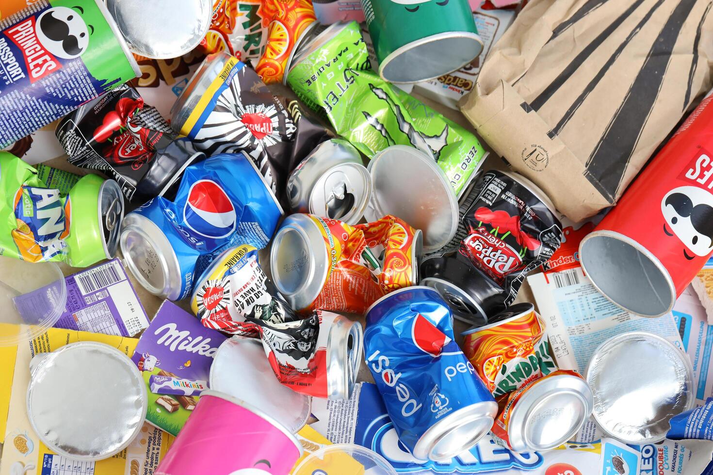 KYIV, UKRAINE - 4 MAY, 2023 Big pile of various wrappings and empty disposable packages and cups from famous branded food photo