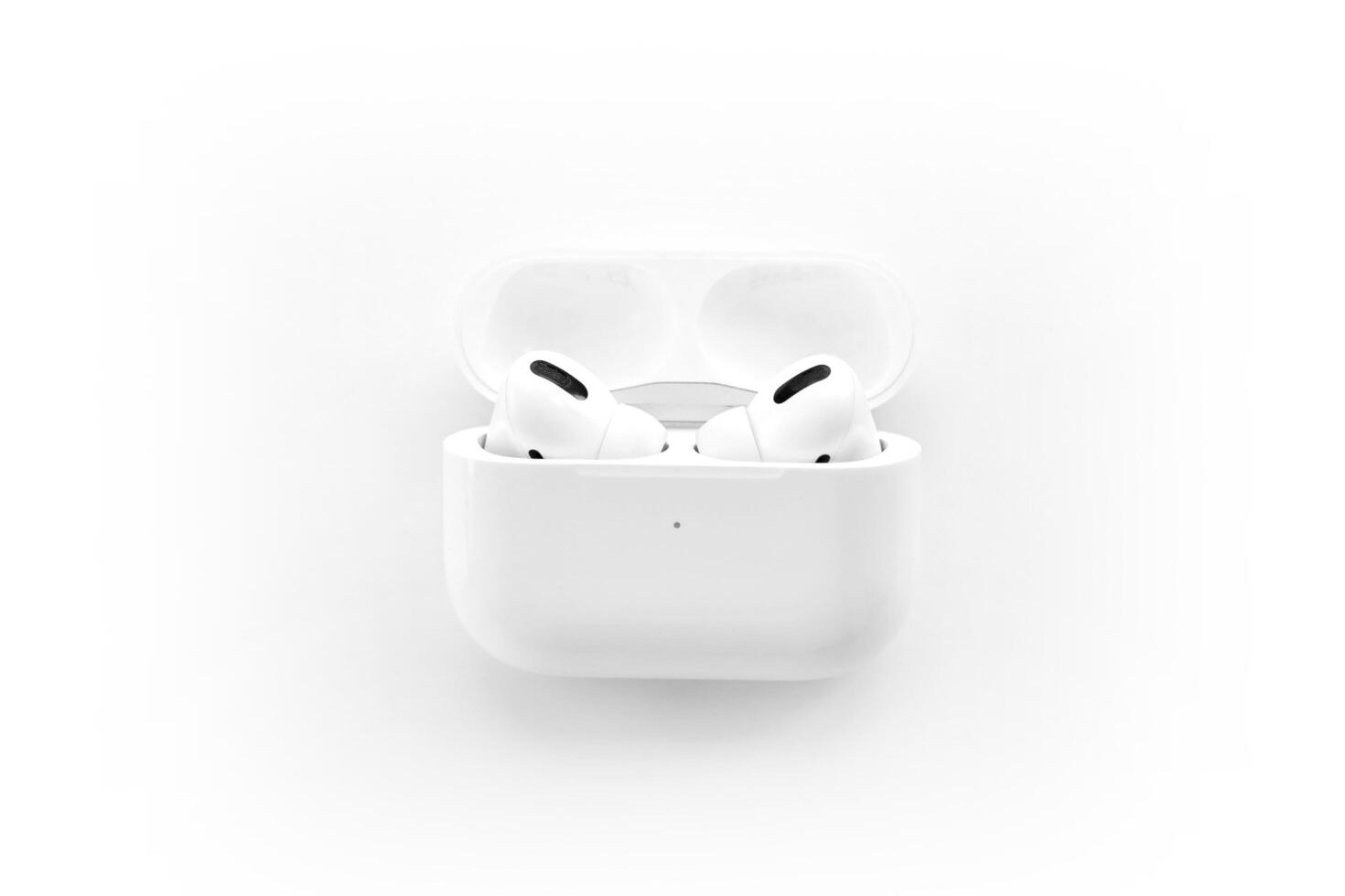 KYIV, UKRAINE - 4 MAY, 2023 Apple AirPods Pro on a white background. Wireless headphones in a charging case photo
