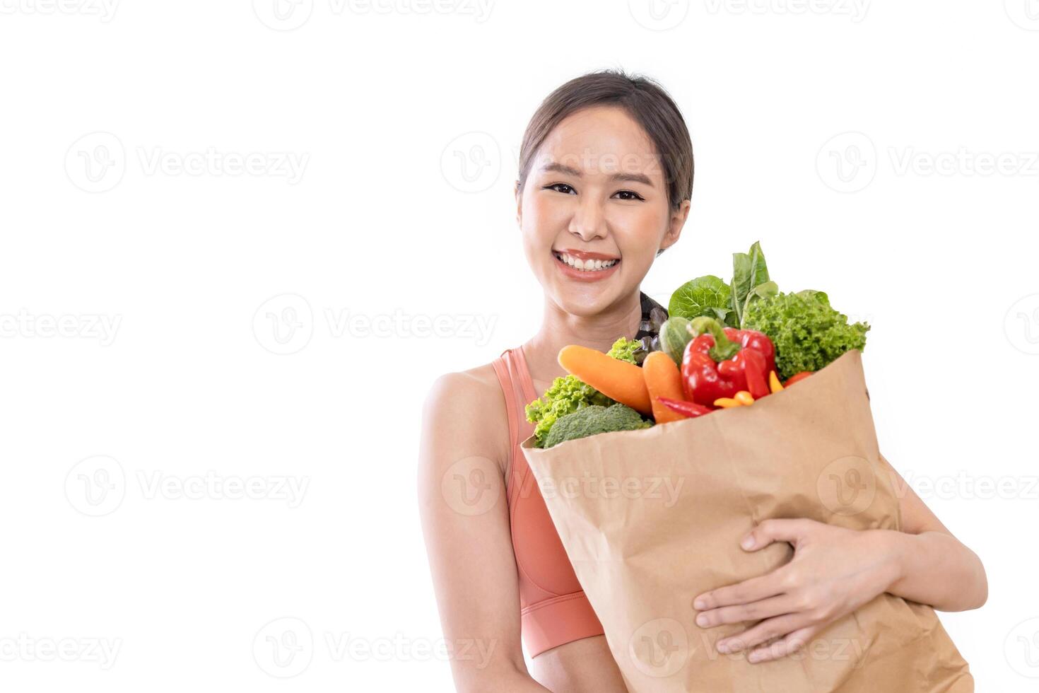 Asian Japanese woman holding shopping bag from supermarket full of organics vegetables and fruits for healthy food and vegetarian salad isolated on white background photo
