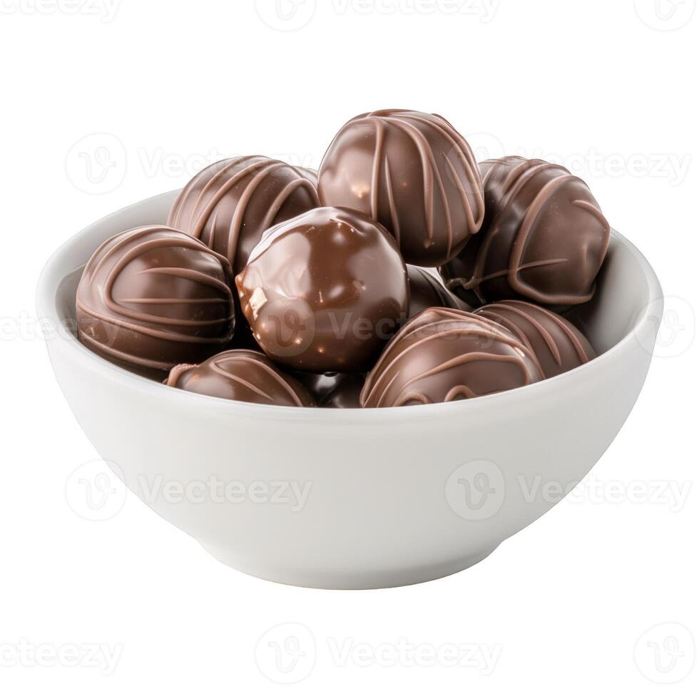 Heap of luxury truffles pralines in a simple white bowl. The candies are soft, ready to eat and unhealthy but yummy. photo