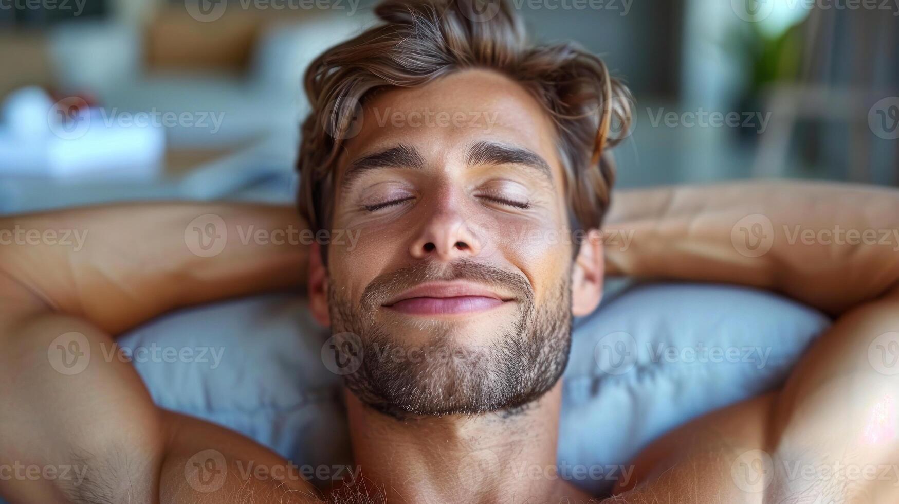 A man lying down on top of a blue pillow photo