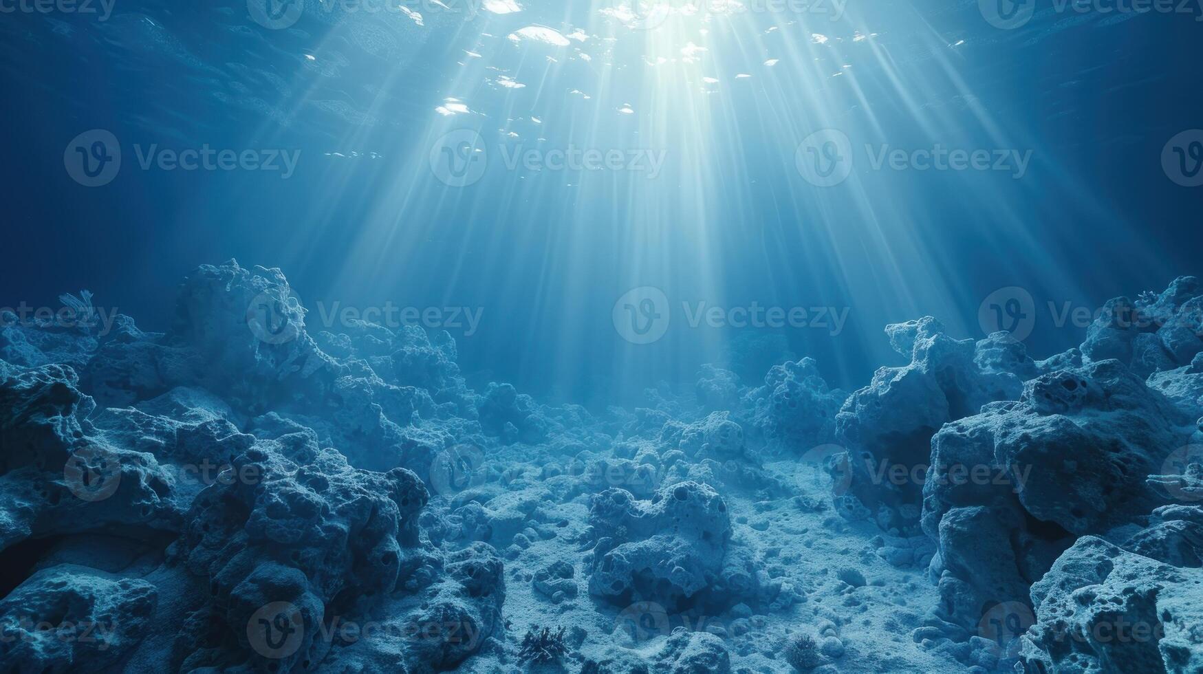 The suns rays illuminate the water over a vibrant coral reef photo