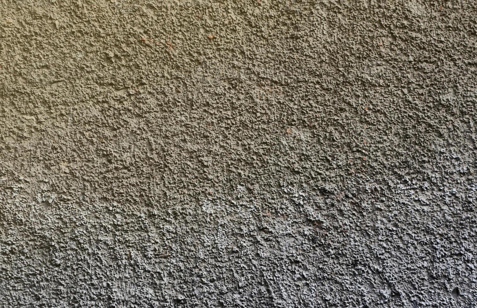 Plastered wall texture with rough relief mortar and light gray color photo
