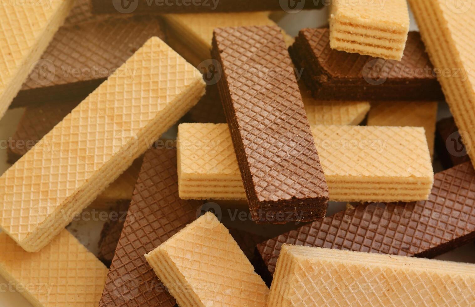 Stacked delicious chocolate wafers in large amount. Two different flavours of classic waffles photo