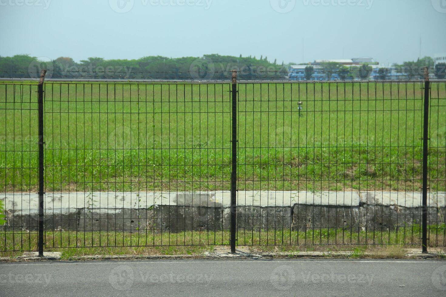 Black iron fence that borders an area photo