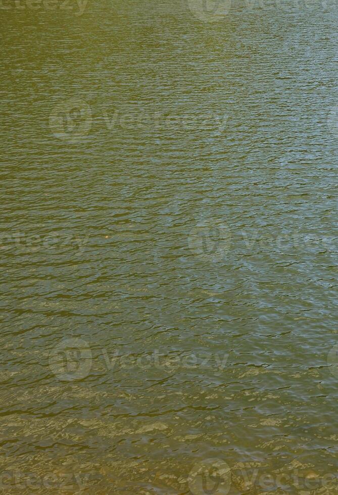 Texture of contaminated river water. The consequences of pollution sources photo