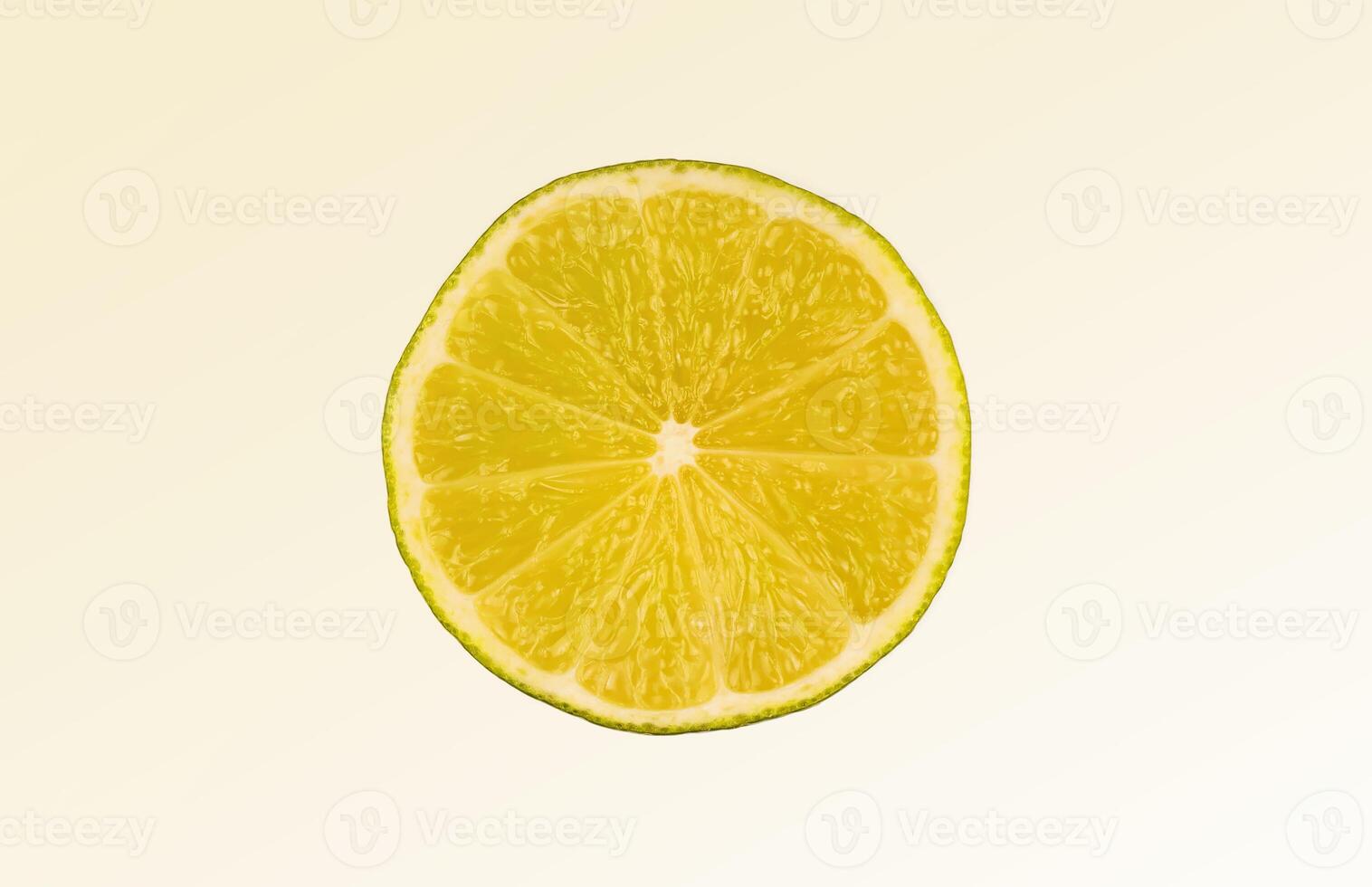 Slice of green lime on light white background. Fresh fruit with copy space photo