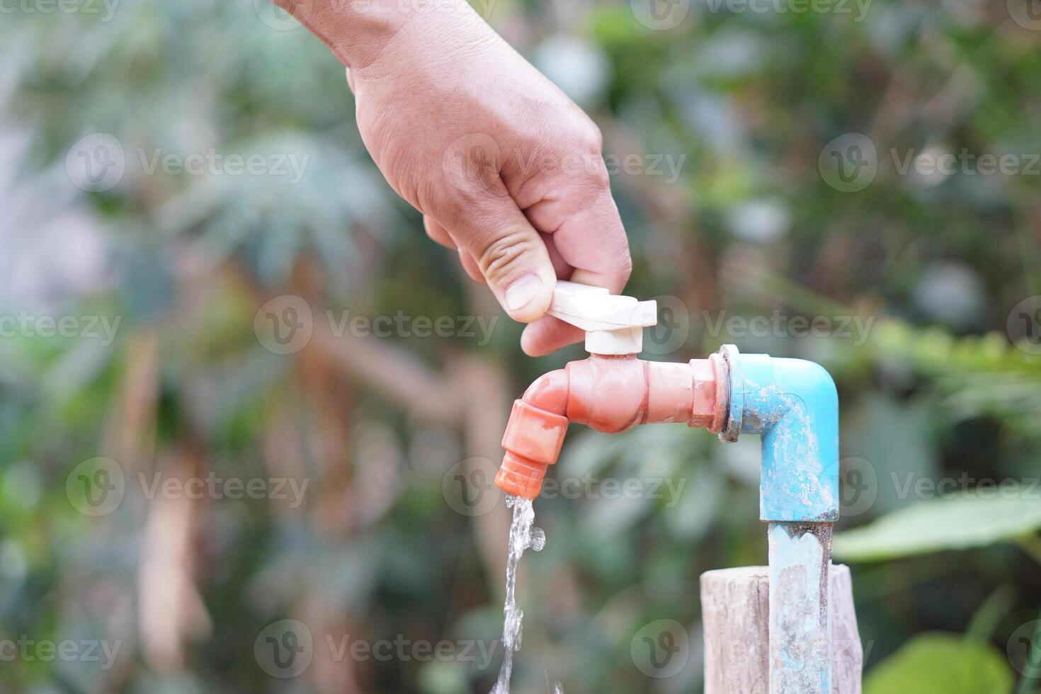 Close up hand is turning off faucet. Concept, Save water for environment. Turn off tap or faucet before leaving. Don't waste water by let it dripping or leaking. photo