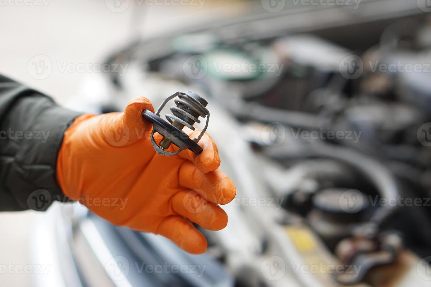 Close up mechanic hand holds metal spare part of car engine. Concept, machine maintenance, fix, repair, diagnose automobile problems by engine specialist. photo