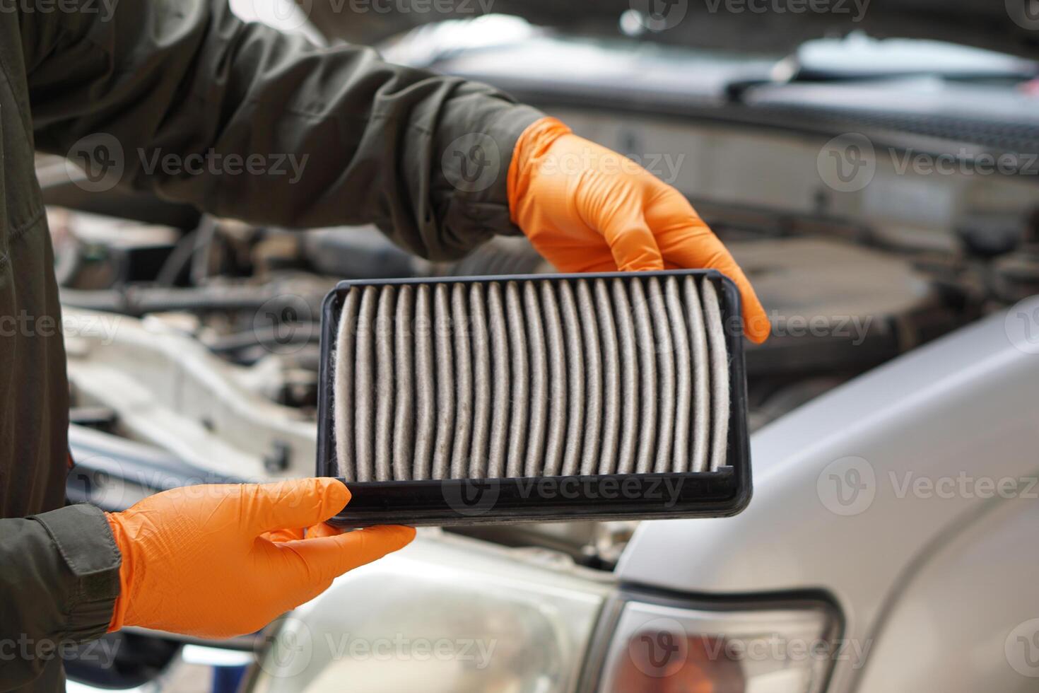 Closeup mechanic's hands hold air filter pad of car engine to check. Concept, car broken,repair and maintenace service. Dirty air fillter need to change for hygienic. photo