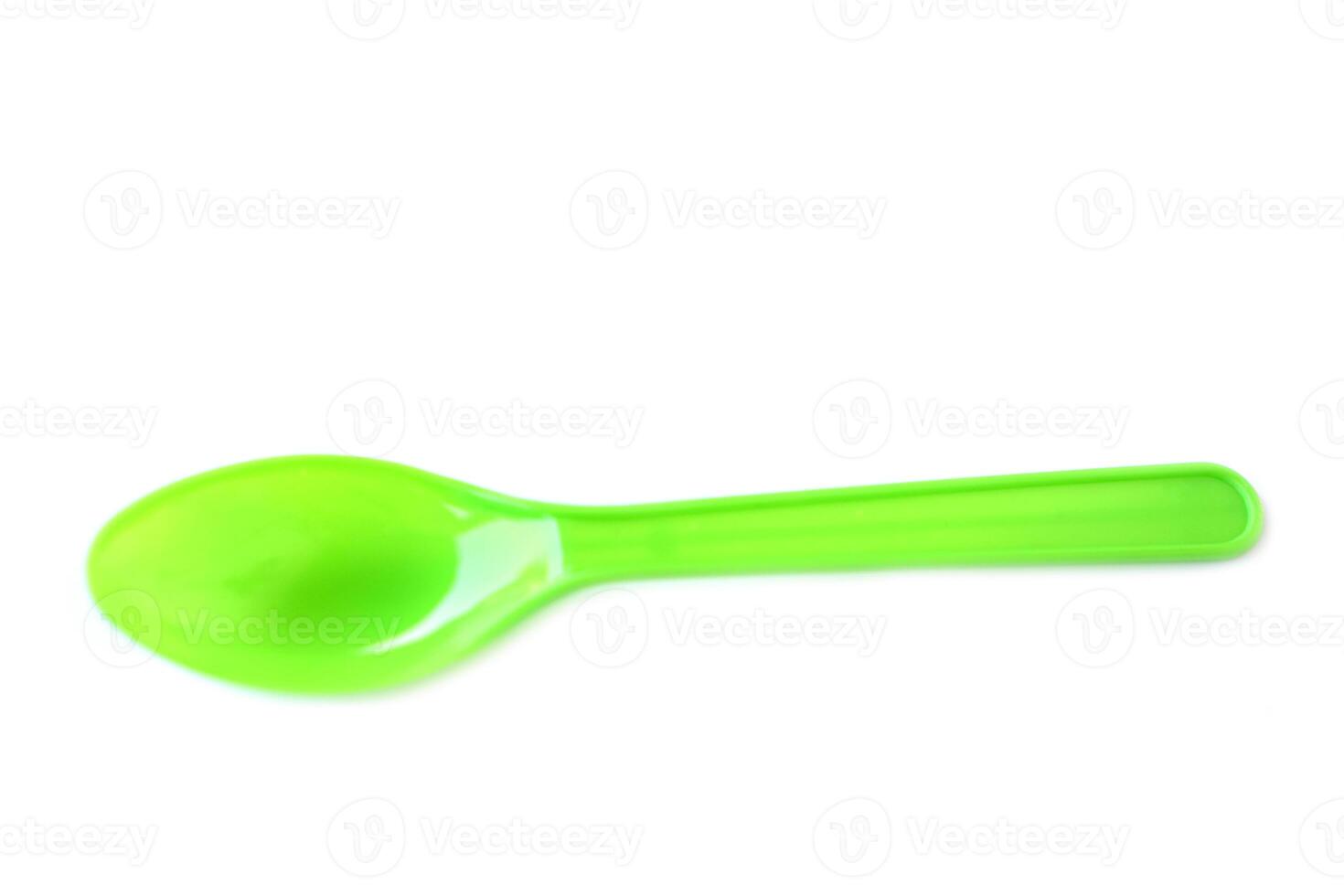 Green plastic disposable spoons isolated on white background. Concept, equipment for eating utensil, can be reuse or recycle to made DIY craft. photo