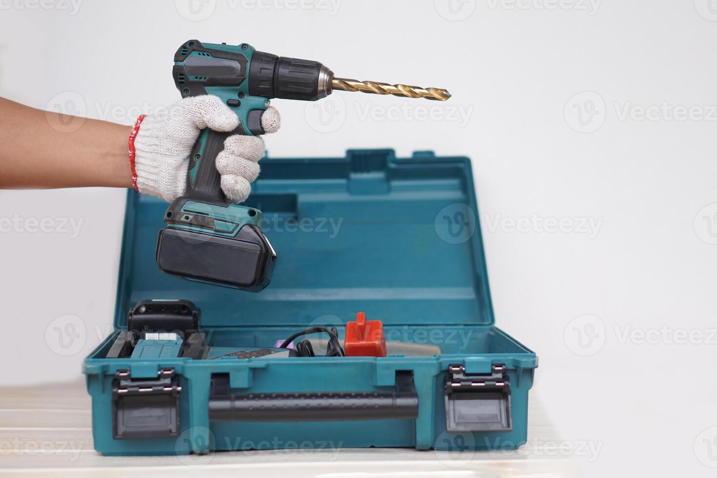 Mechanic hand holds screwdriver or drill. Concept, Handyman tool, use for construction, fix , repair or DIY crafts. Portable cordless electric machine to make hard work easier. photo