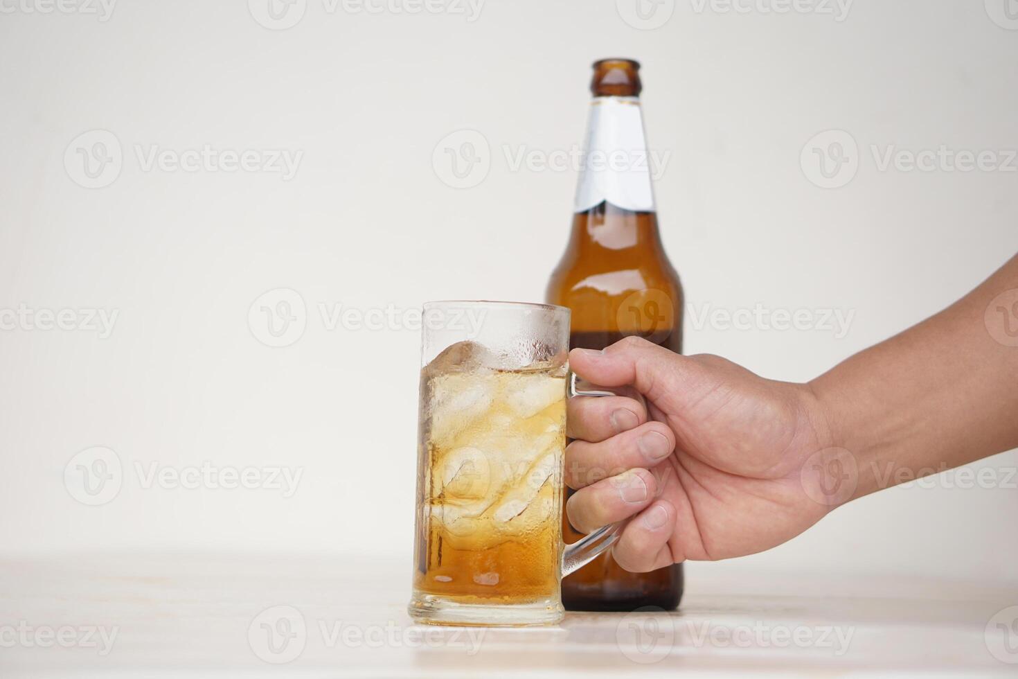 Close up hand hold glass mug of alcoholic beverage. Concept, time for celebrate with cool favorite drink in party or relaxation after work. Drink for health or fun but don't drink for drunk. photo