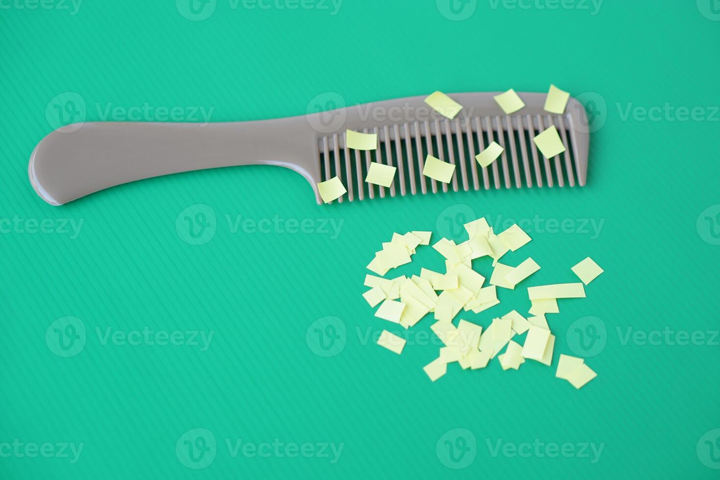 Comb and small pieces of paper. Equipment, prepared to do experiment about static electricity. Green background. Concept, Science lesson, fun and easy experiment. Education. Teaching aids. photo