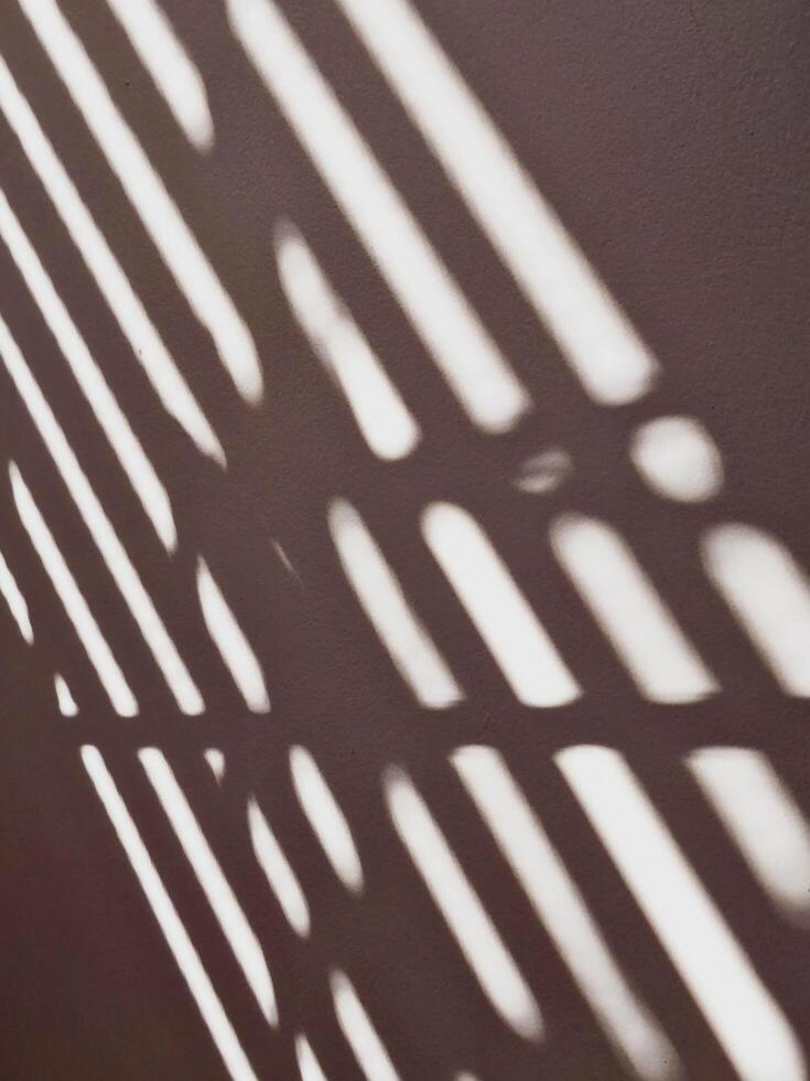 Lines of light and shadow on the cement wall. photo