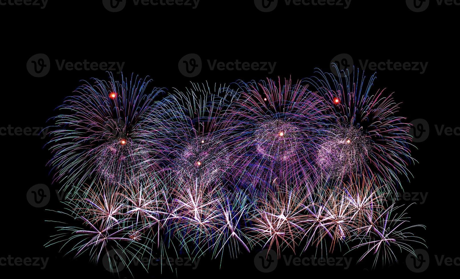 Colorful celebration fireworks isolated on a black sky background. photo