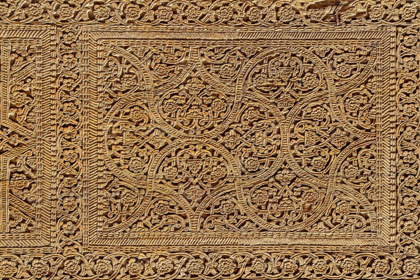 Fragment of an ancient carved wooden door. Ornate. photo