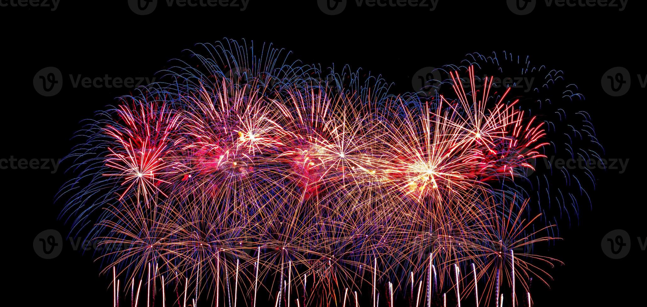 Colorful celebration fireworks isolated on a black sky background. photo