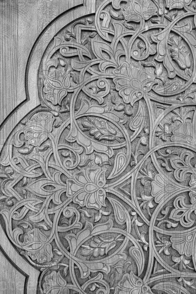 Black and white carved wooden doors with patterns and mosaics. 7 photo