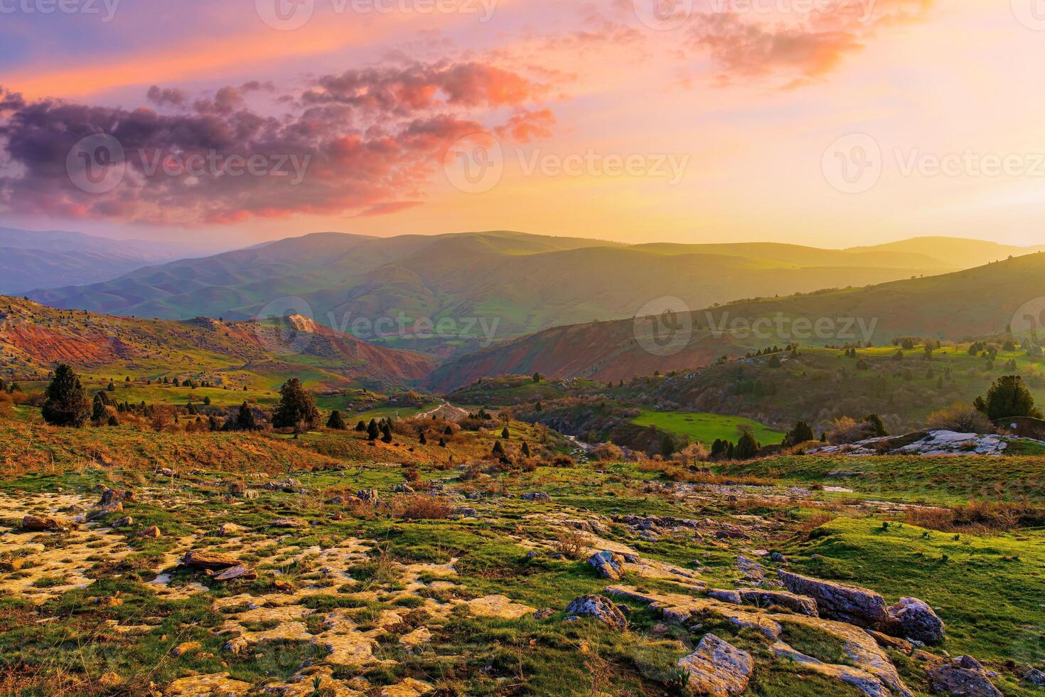Foggy sunset or dawn in the mountains covered with grass and cloudy dramatic sky. photo
