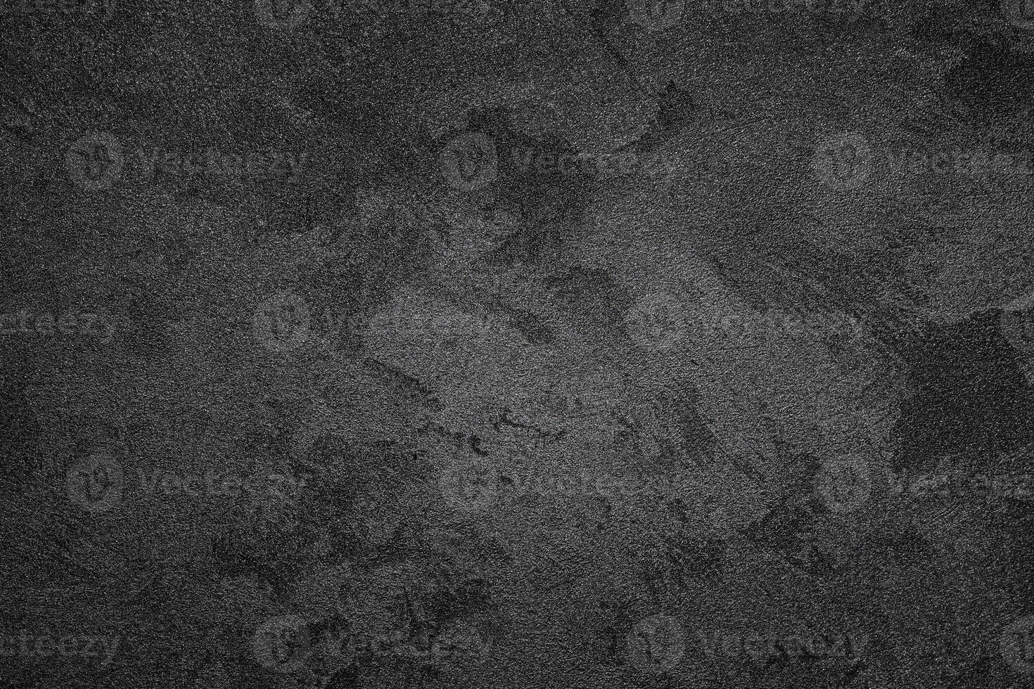 Texture of black decorative plaster or concrete with vignette. Abstract grunge background. photo