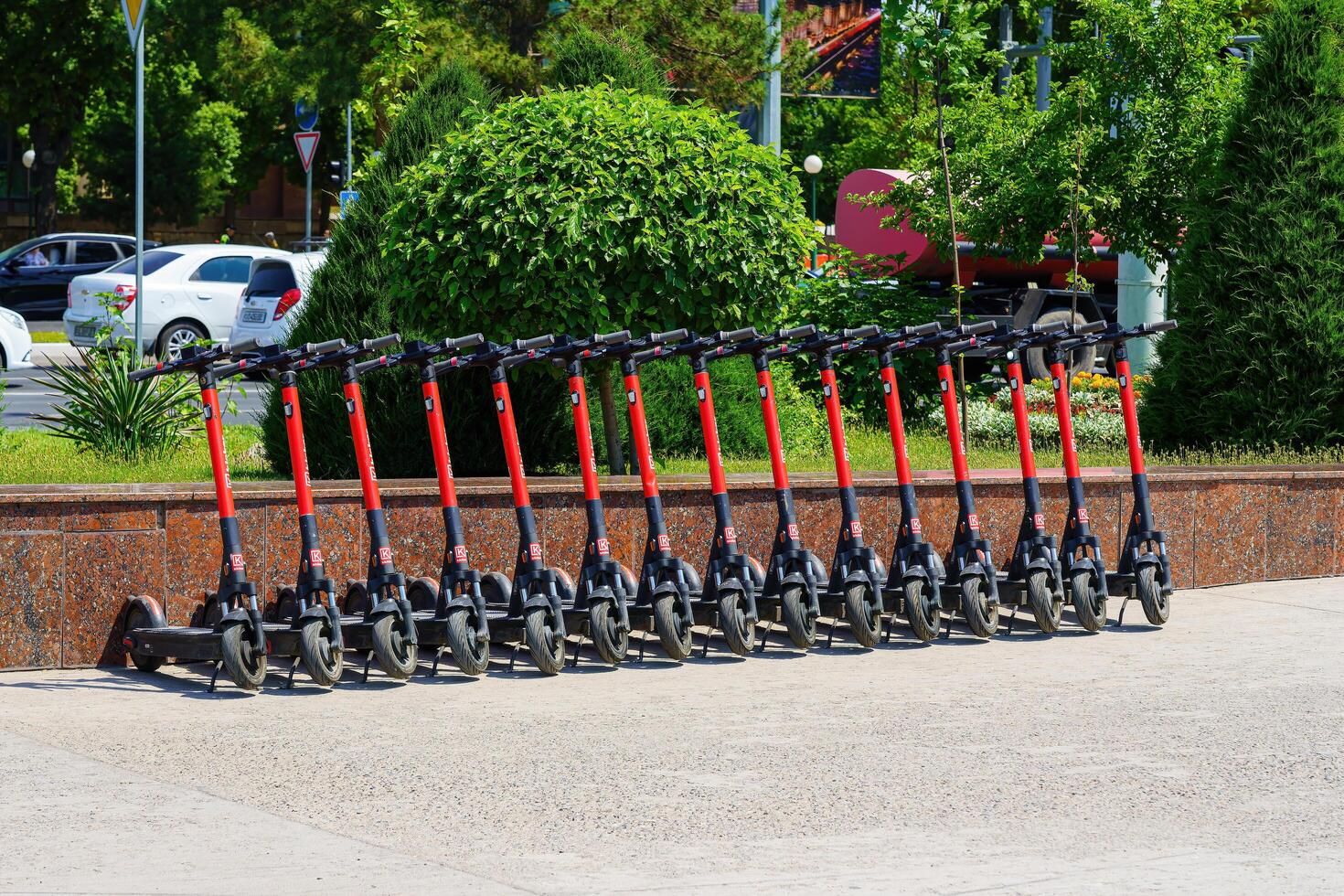Tashkent, Uzbekistan - May 25, 2023 Rental of electric scooters parked on the sidewalk. photo