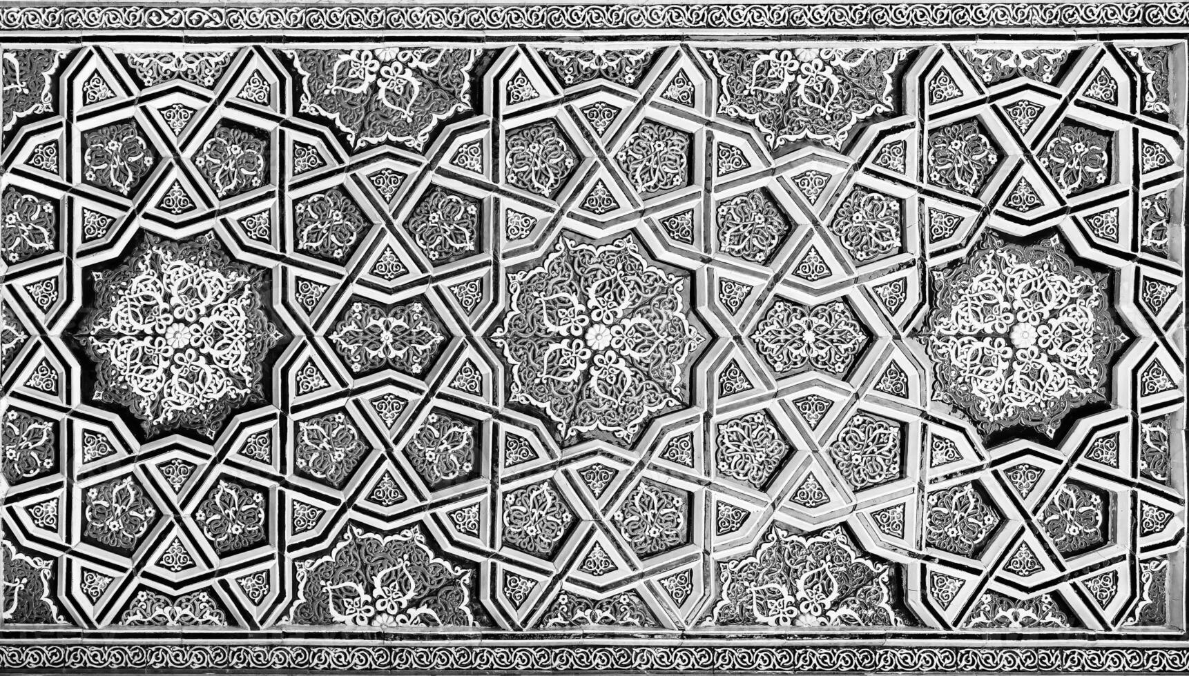 Geometric traditional Islamic ornament. Fragment of a ceramic mosaic. Black and white. photo