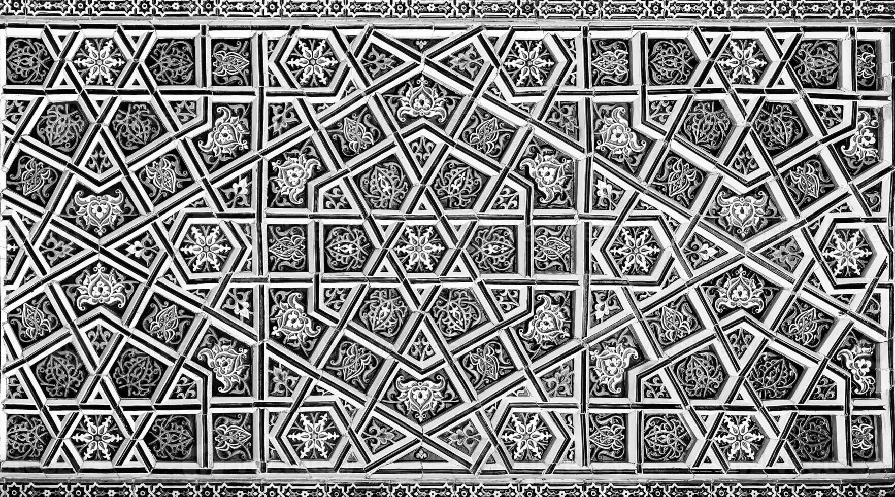 Geometric traditional Islamic ornament. Fragment of a ceramic mosaic. Black and white. photo