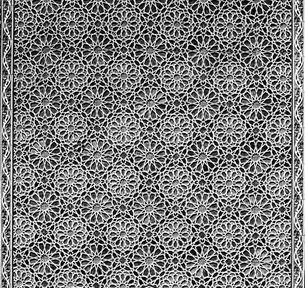 Geometric traditional Islamic ornament. Fragment of a ceramic mosaic. Black and white. photo