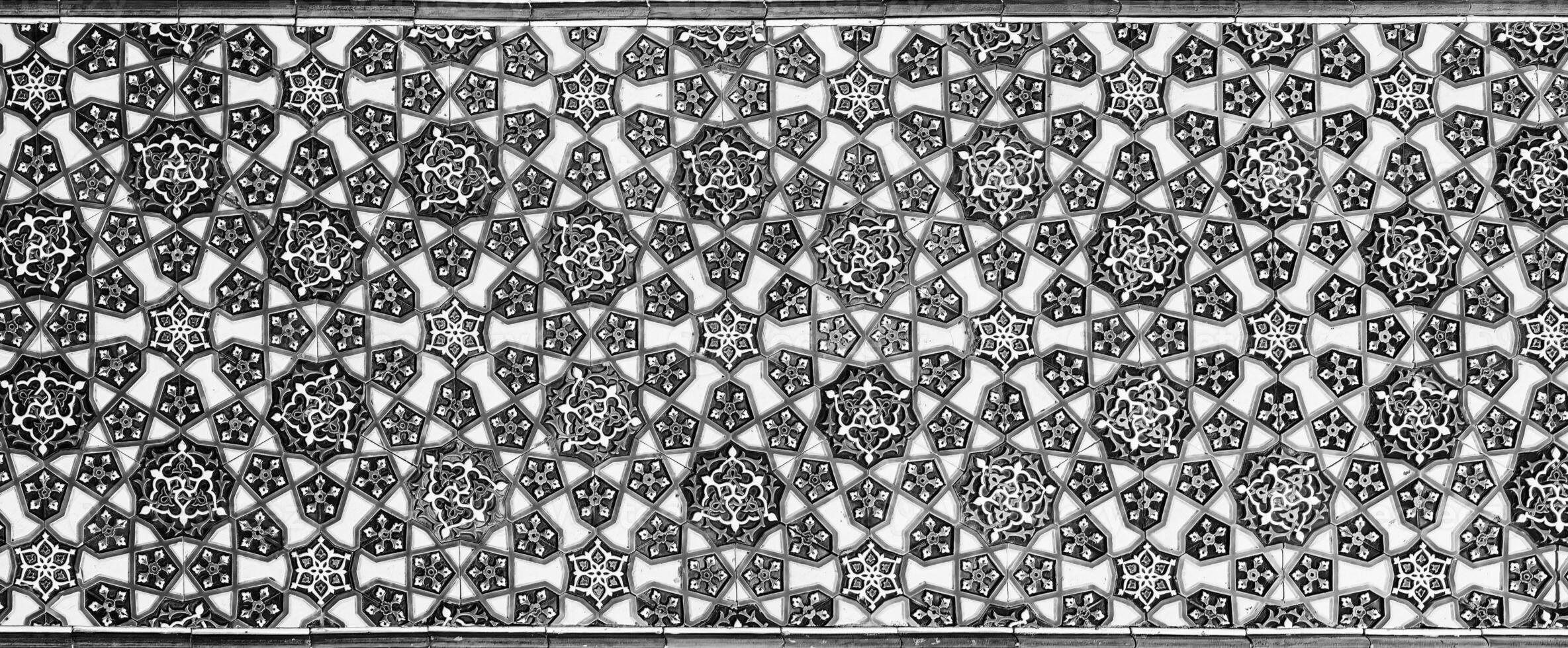 Geometric traditional Islamic ornament. Fragment of a ceramic mosaic. Black and white. photo