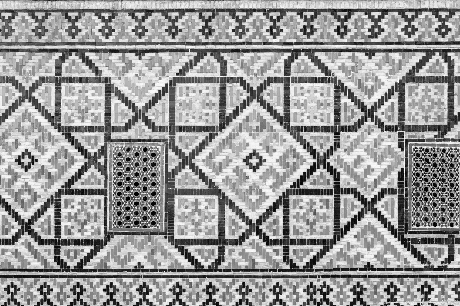 Geometric traditional Islamic ornament. Fragment of a ceramic mosaic. Black and white. photo