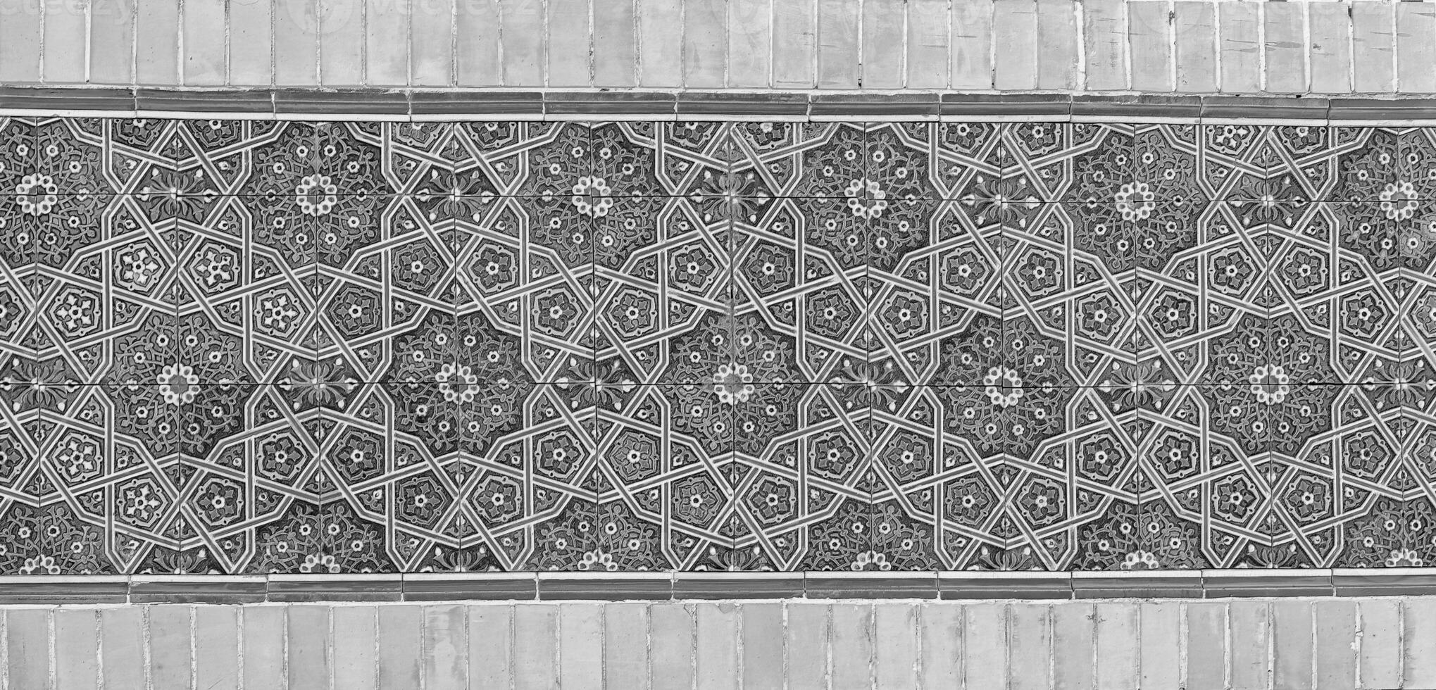 Geometric traditional Islamic ornament. Fragment of a ceramic mosaic. Black and white. photo