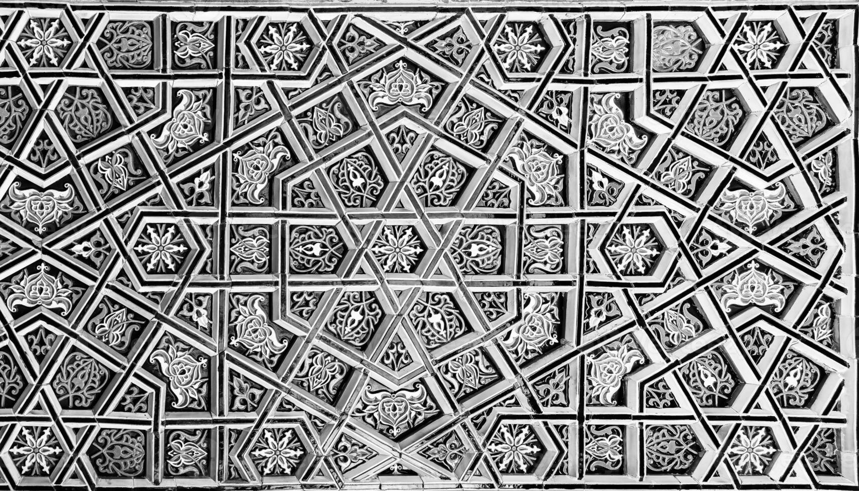 Geometric traditional Islamic ornament. Fragment of a ceramic mosaic. Black and white. photo