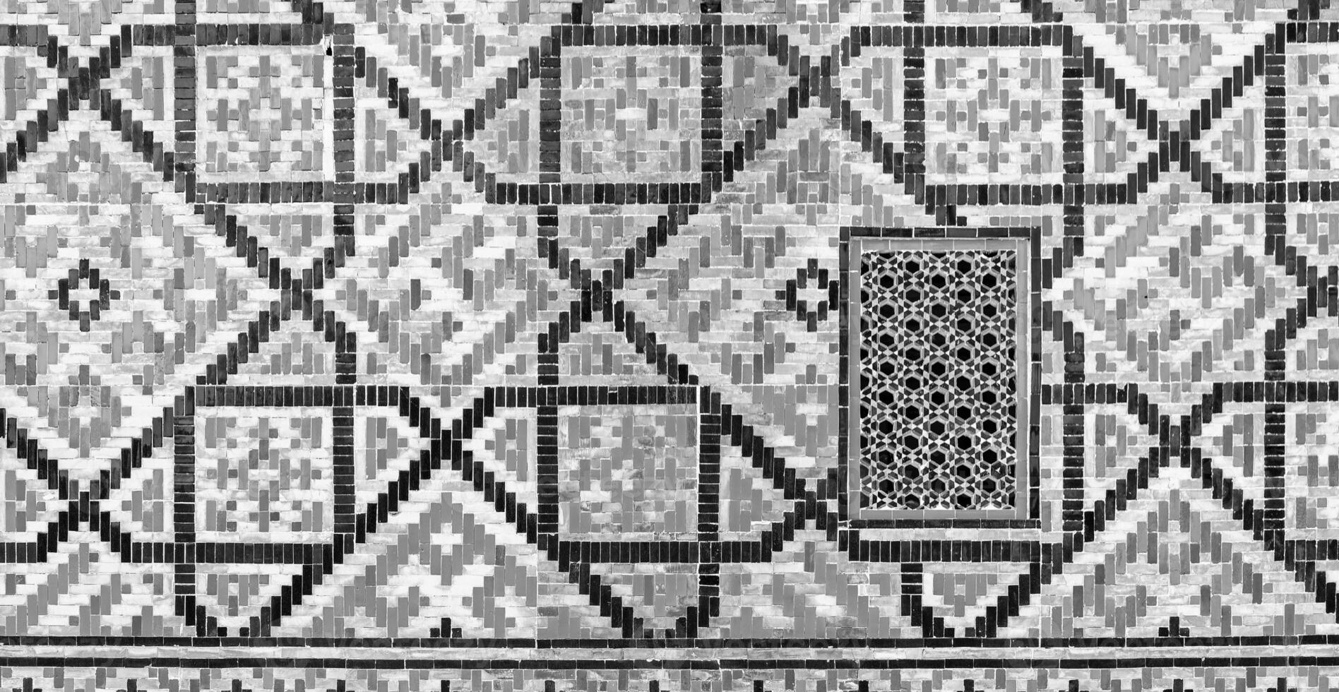 Geometric traditional Islamic ornament. Fragment of a ceramic mosaic. Black and white. photo