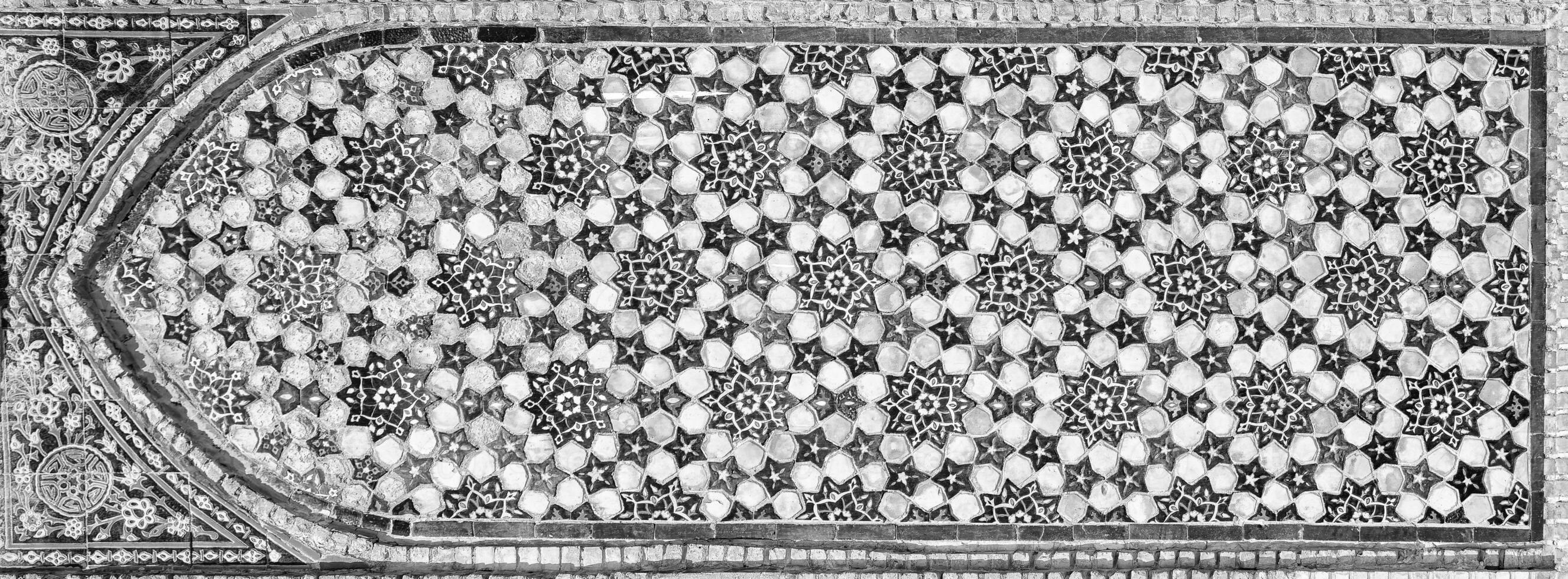 Geometric traditional Islamic ornament. Fragment of a ceramic mosaic. Black and white. photo