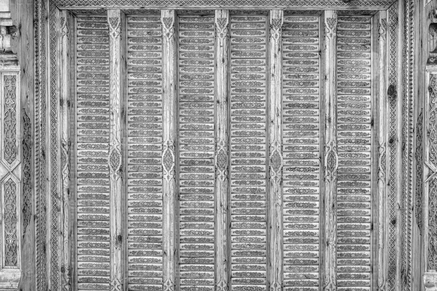 Fragment of an ancient carved wooden pattern. Ornate. Abstract background. Black and white. photo