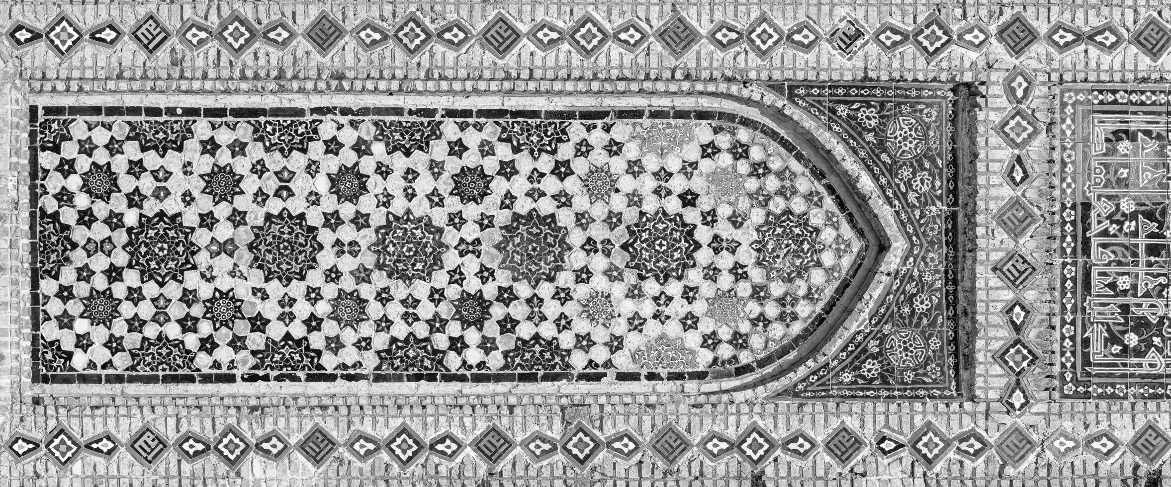 Geometric traditional Islamic ornament. Fragment of a ceramic mosaic. Black and white. photo